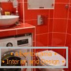 Tuile orange dans la salle de bain avec machine à laver