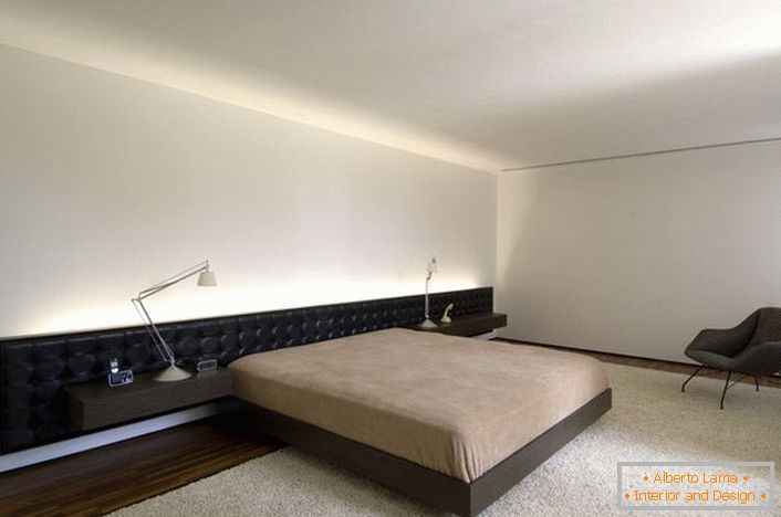 Le lit avec une tête de lit souple allongée s'intègre parfaitement dans le projet de design.