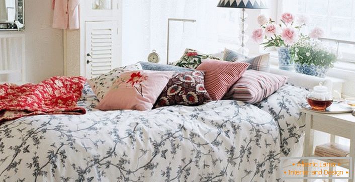 Correctement décoré dans le style d'un lit de campagne. Dans les meilleures traditions du pays, un oreiller de couleurs contrastantes et un plaid sont fabriqués.