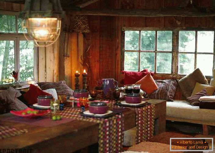 De nombreux oreillers, des nappes colorées sur les tables contribueront à créer un lieu confortable dans le salon du pays.