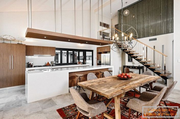 Une cuisine élégante de style loft n'est pas surchargée de détails. Un ensemble de cuisine fonctionnel et pratique divise l'espace en un espace de travail et une salle à manger.