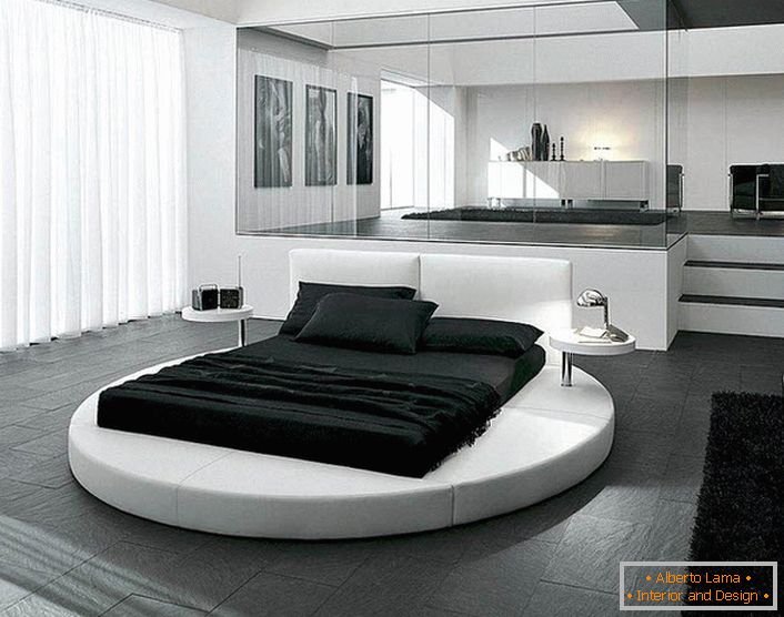 La conception de la chambre dans le style du minimalisme est soulignée par des meubles bien choisis. Un détail intéressant de l’intérieur est un lit rond.